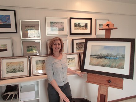 Me with a new landscape painting and wall of art. 